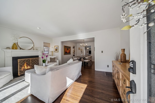 living room featuring ornamental molding, a notable chandelier, and dark hardwood / wood-style floors