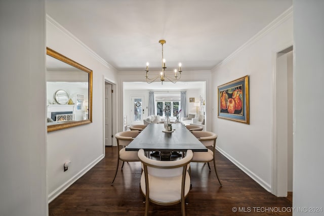 dining room with dark wood-type flooring, a chandelier, and crown molding