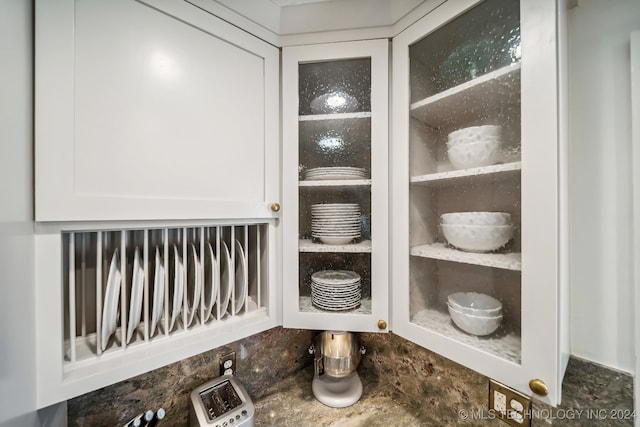 details with dark stone counters and white cabinets