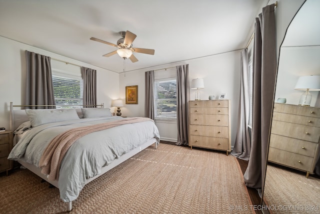 bedroom with light colored carpet and ceiling fan