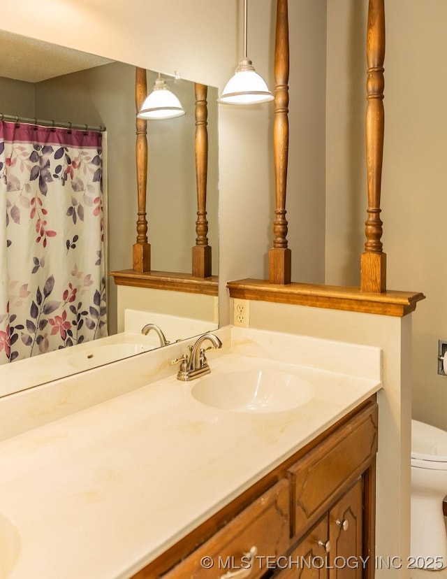 bathroom featuring vanity and toilet