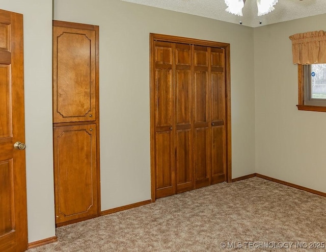 unfurnished bedroom with light colored carpet, baseboards, and a closet