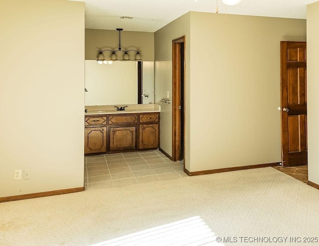 bathroom featuring baseboards and vanity