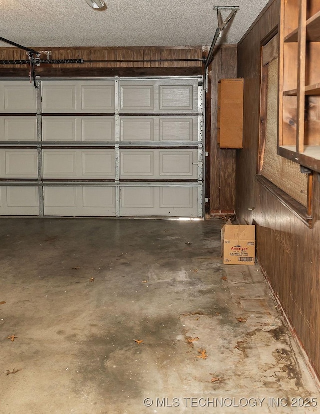 garage featuring wood walls