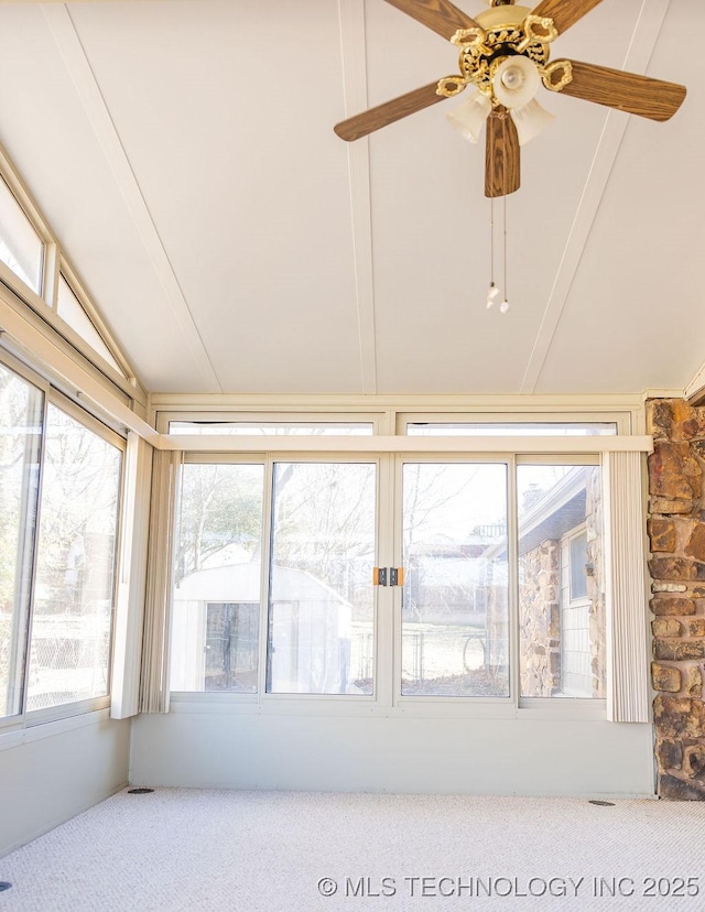 unfurnished sunroom featuring carpet flooring, vaulted ceiling, and healthy amount of natural light