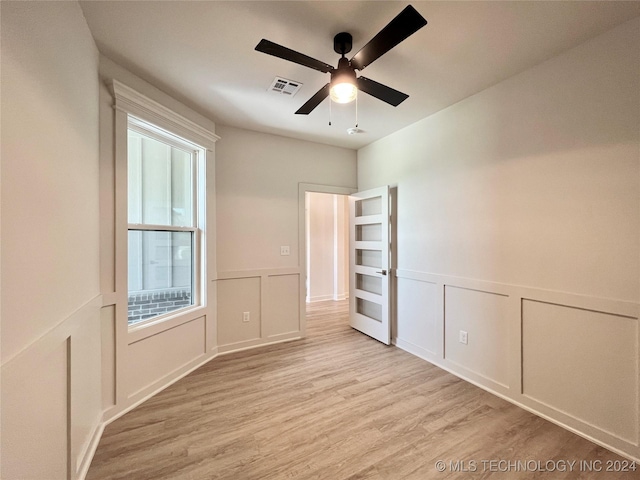 spare room with ceiling fan and light hardwood / wood-style floors