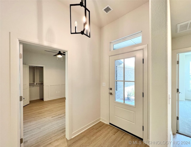 doorway to outside with light hardwood / wood-style flooring and ceiling fan