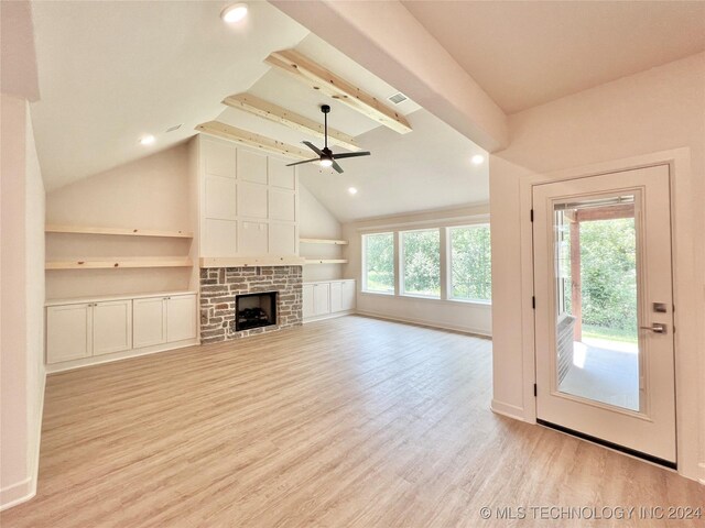 unfurnished living room with light hardwood / wood-style floors, ceiling fan, plenty of natural light, and lofted ceiling with beams