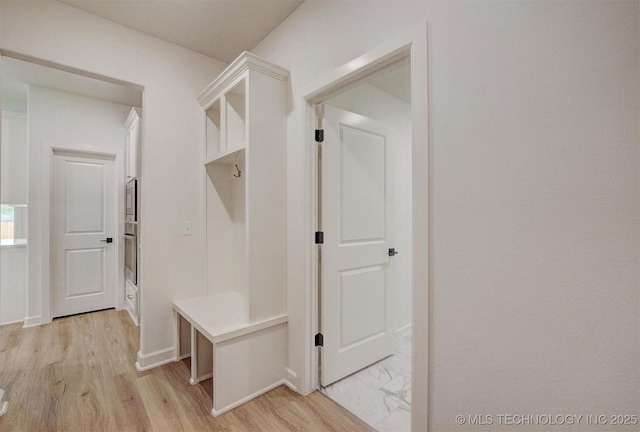 mudroom with baseboards and light wood-type flooring