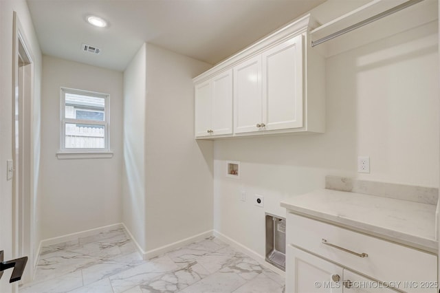 laundry area featuring visible vents, marble finish floor, washer hookup, and cabinet space