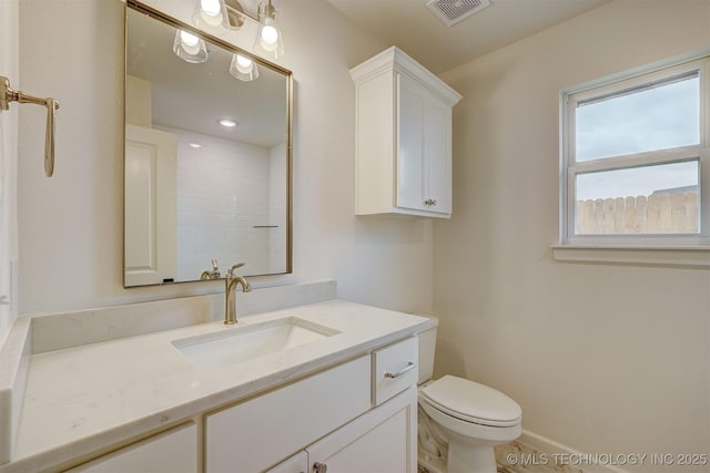 bathroom with visible vents, vanity, and toilet