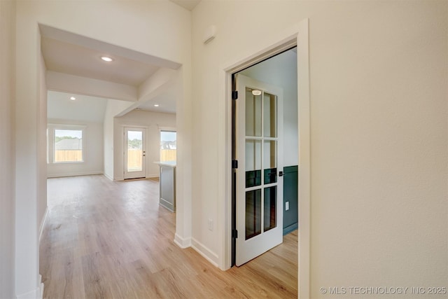 hall with recessed lighting, light wood-style flooring, and baseboards