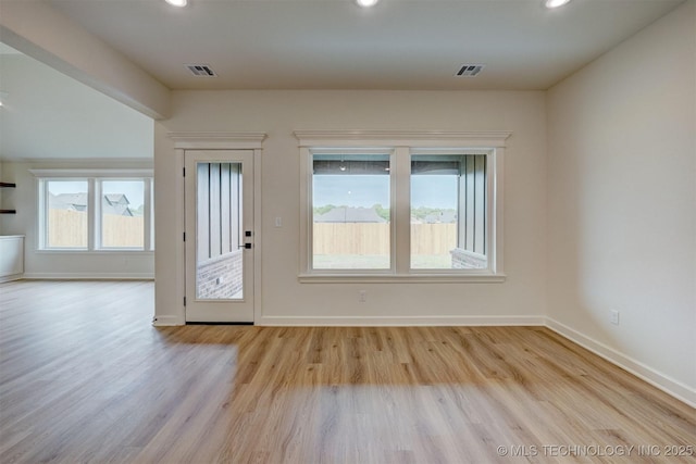 entryway featuring baseboards, wood finished floors, and visible vents