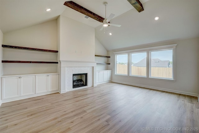 unfurnished living room featuring a ceiling fan, lofted ceiling with beams, light wood-type flooring, a fireplace, and recessed lighting