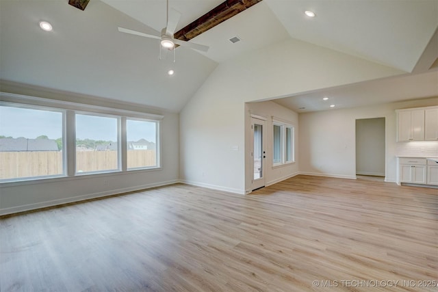 unfurnished living room with vaulted ceiling, baseboards, visible vents, light wood-style floors, and a ceiling fan