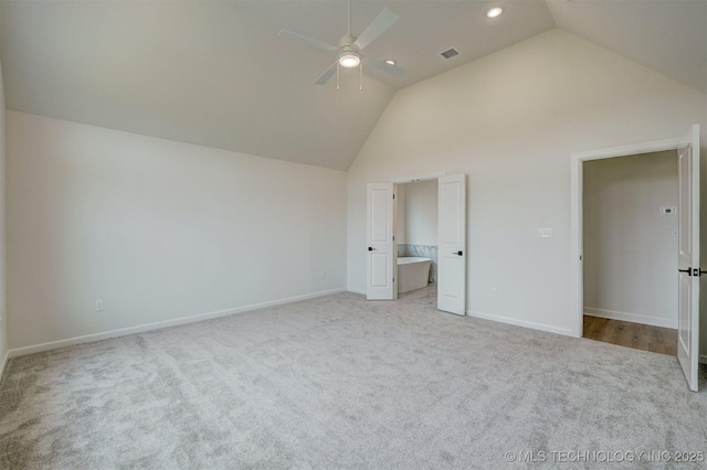 unfurnished bedroom featuring light carpet, baseboards, visible vents, recessed lighting, and high vaulted ceiling