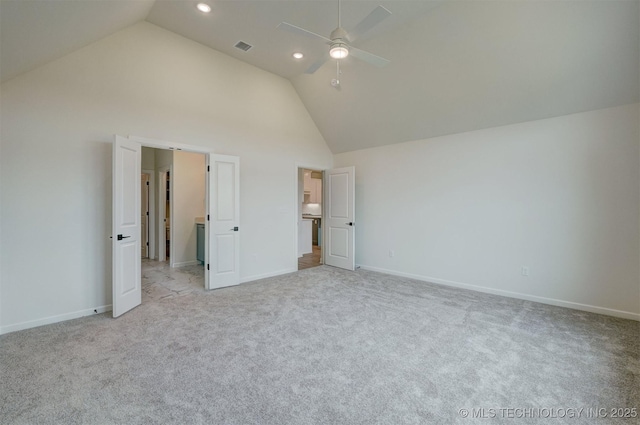unfurnished bedroom with recessed lighting, visible vents, light colored carpet, baseboards, and high vaulted ceiling