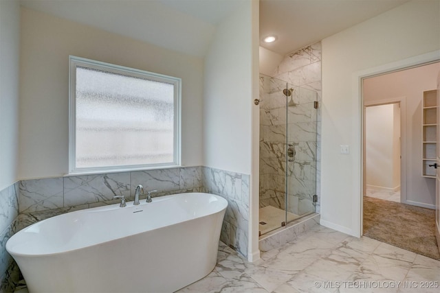 full bathroom featuring marble finish floor, a freestanding bath, a marble finish shower, and recessed lighting