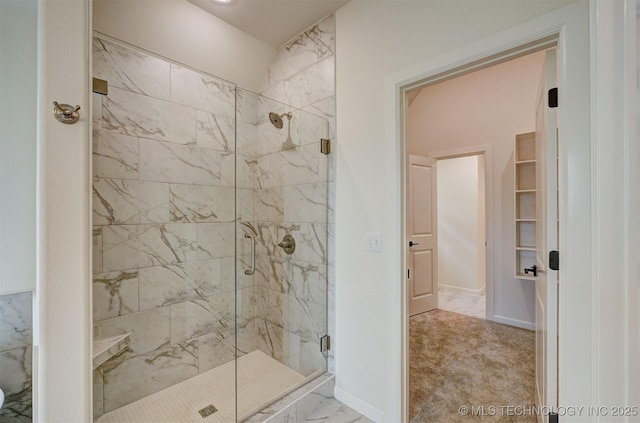 bathroom featuring a shower stall, marble finish floor, and baseboards