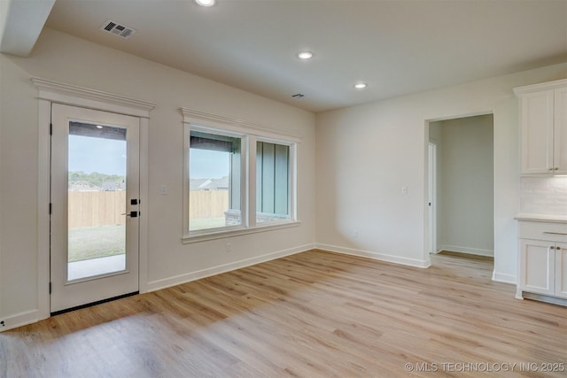 interior space featuring baseboards, recessed lighting, visible vents, and light wood-type flooring