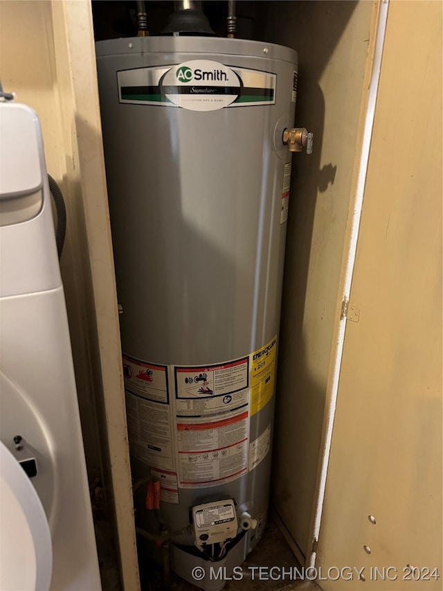 utility room featuring water heater