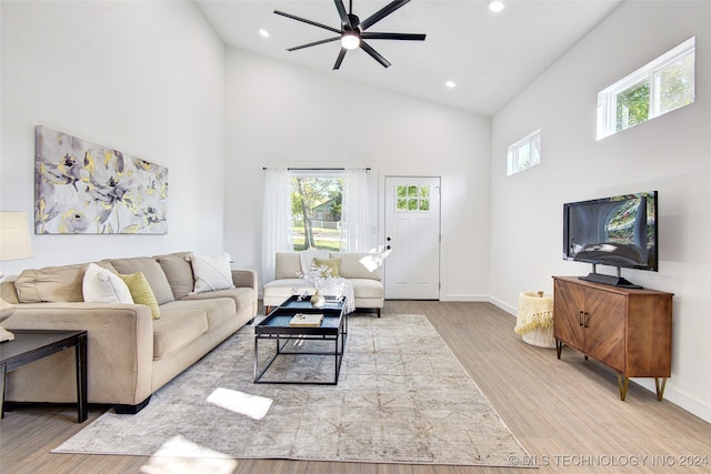 living room featuring light wood-type flooring, high vaulted ceiling, and ceiling fan