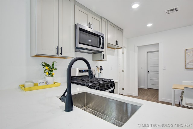 kitchen featuring hardwood / wood-style floors and appliances with stainless steel finishes