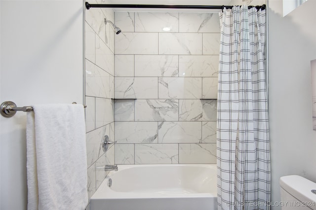 bathroom with shower / bath combo and toilet