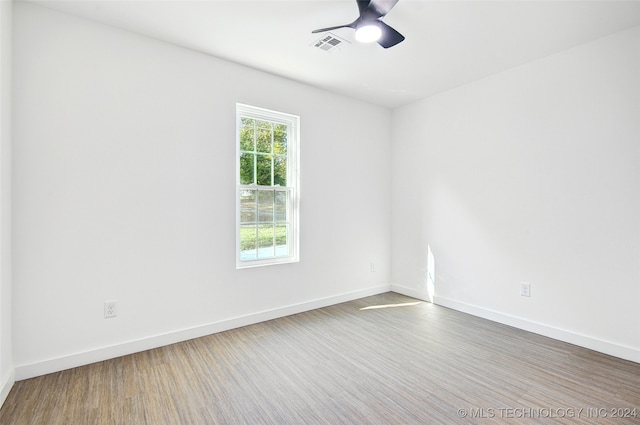 spare room with wood-type flooring and ceiling fan