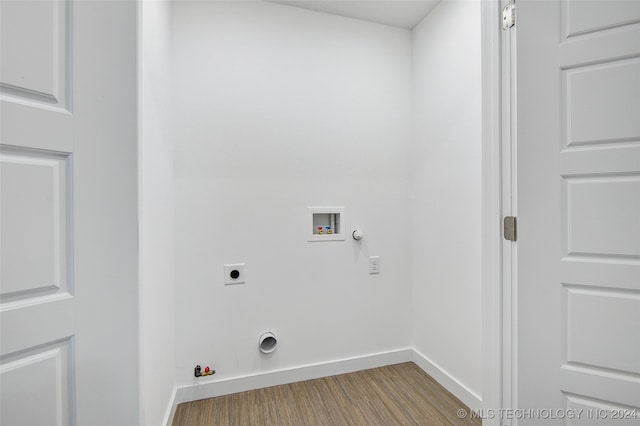 clothes washing area featuring hardwood / wood-style flooring, hookup for a gas dryer, electric dryer hookup, and hookup for a washing machine