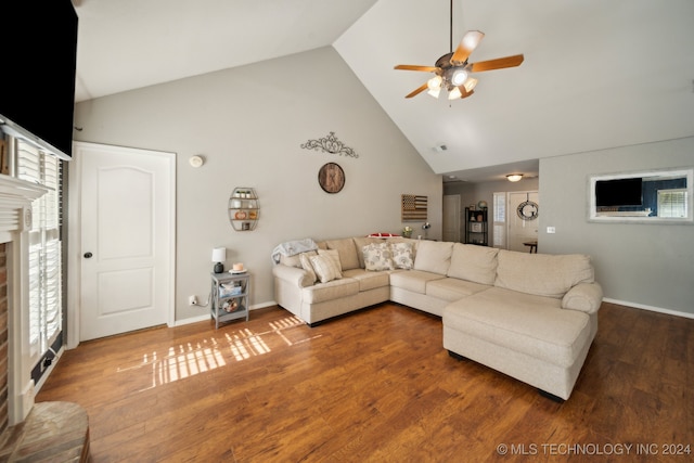 living room with wood-type flooring and a brick fireplace