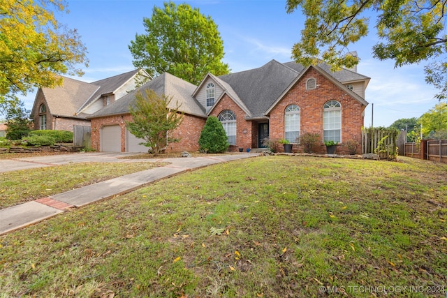 front facade featuring a garage and a front lawn