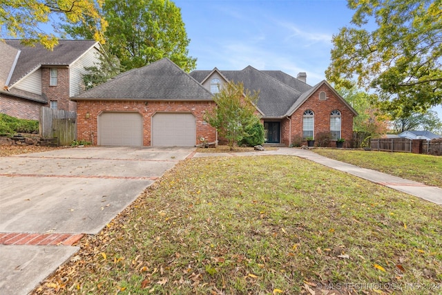 2602 E 74th Pl, Tulsa, OK 74136 - view of front of home featuring brick siding, an attached garage, driveway, a shingled roof, and a chimney