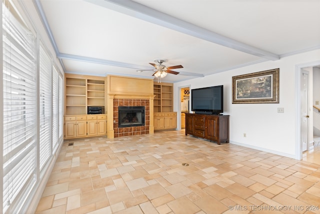 unfurnished living room featuring a fireplace, ceiling fan, a healthy amount of sunlight, and ornamental molding