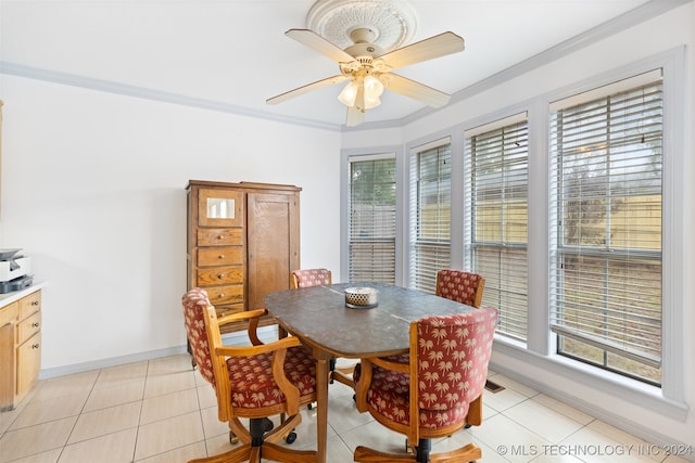 dining area with plenty of natural light, light tile patterned flooring, and crown molding