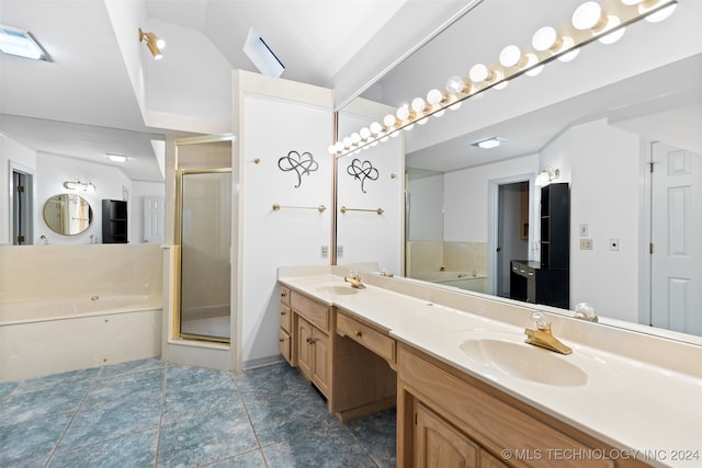 bathroom featuring shower with separate bathtub, tile patterned floors, and vanity