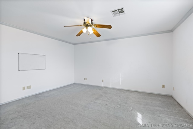 spare room featuring ceiling fan and crown molding