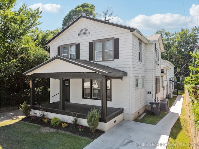 view of property featuring a porch and cooling unit