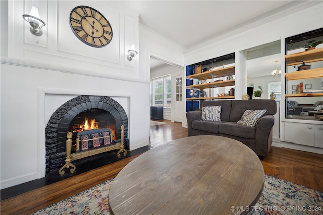 living room with dark hardwood / wood-style floors and a fireplace