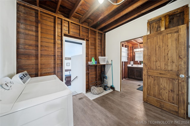 washroom with wooden ceiling, wood-type flooring, wooden walls, and independent washer and dryer