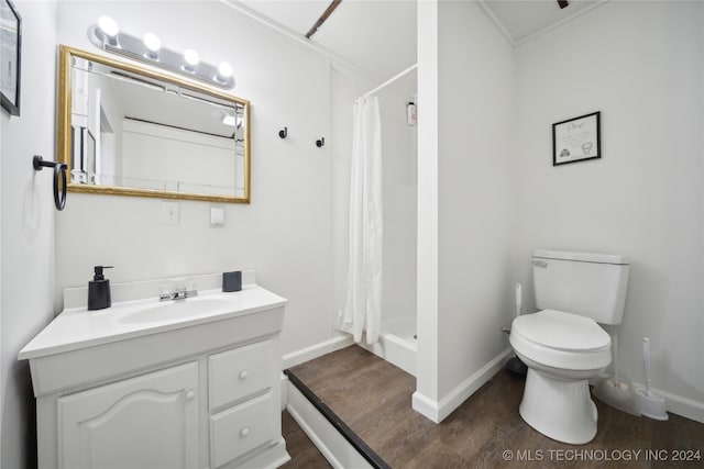 bathroom featuring toilet, vanity, hardwood / wood-style floors, and curtained shower