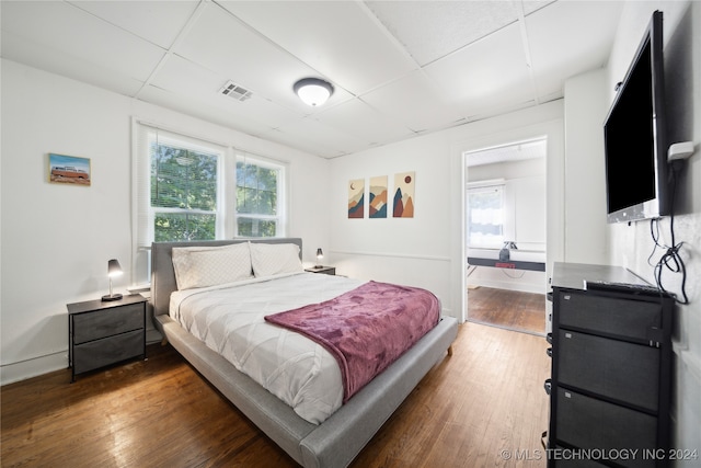 bedroom with dark hardwood / wood-style flooring