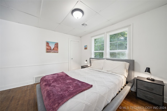 bedroom with dark hardwood / wood-style flooring