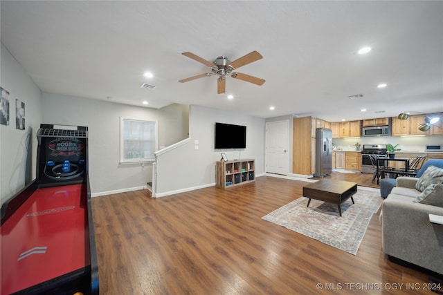 living room with hardwood / wood-style floors and ceiling fan