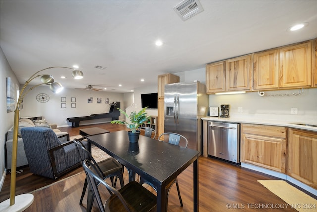 kitchen featuring appliances with stainless steel finishes, ceiling fan, light brown cabinetry, and dark hardwood / wood-style flooring