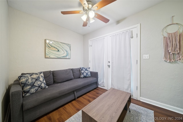 living room with ceiling fan and dark hardwood / wood-style floors