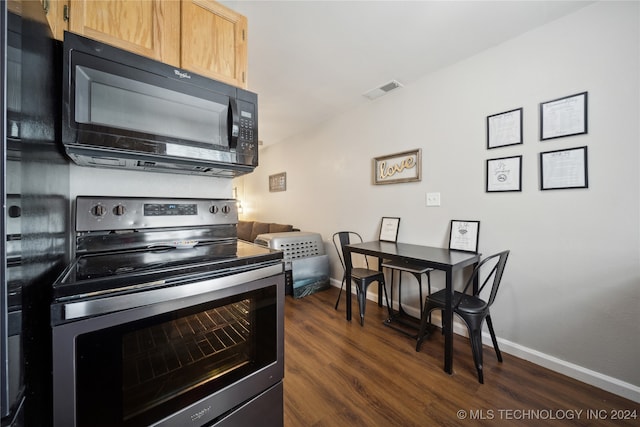 kitchen with light brown cabinets, dark wood-type flooring, and stainless steel electric stove