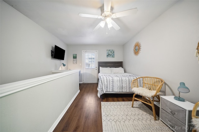 bedroom with ceiling fan and dark hardwood / wood-style flooring