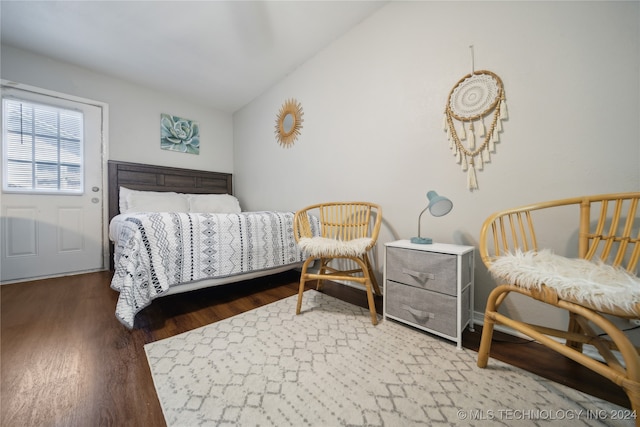 bedroom with dark hardwood / wood-style flooring and vaulted ceiling