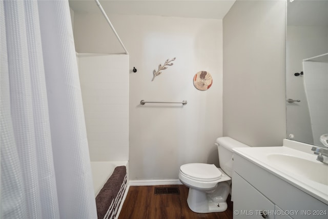 full bathroom featuring hardwood / wood-style flooring, vanity, toilet, and shower / bath combo with shower curtain